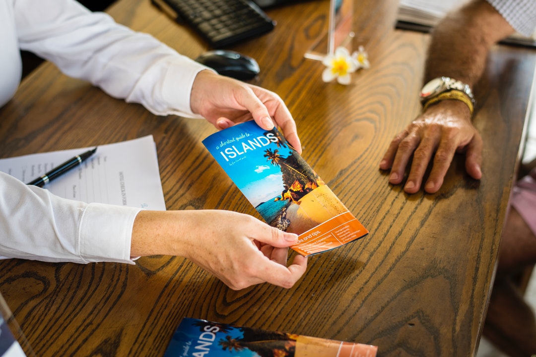 person holding brochure